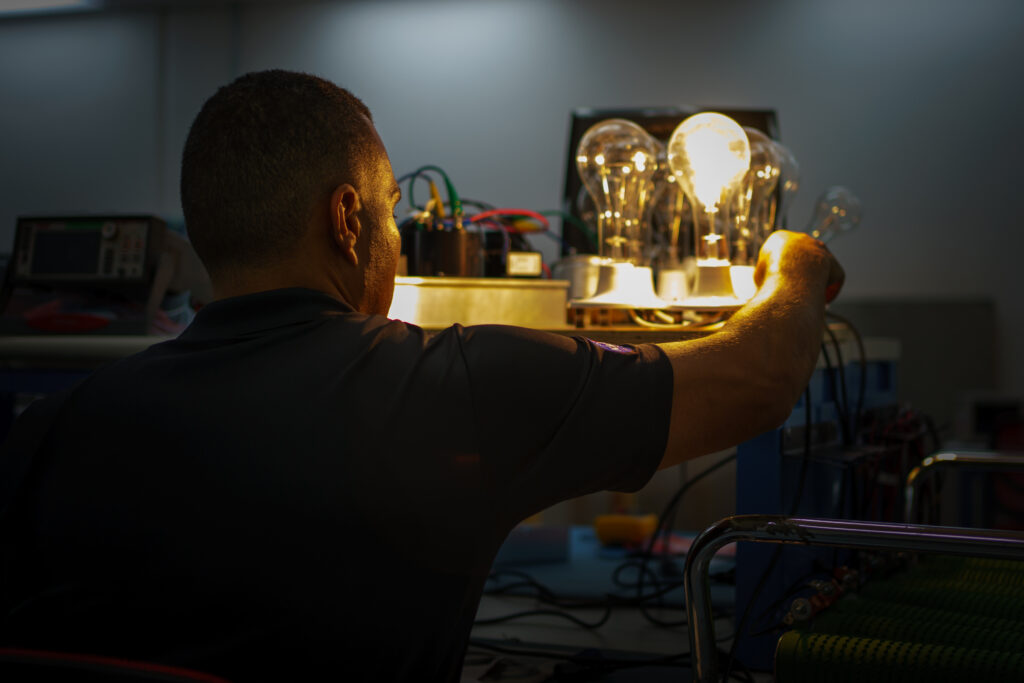 Loay Elbasyouni examining illuminated laboratory hardware.