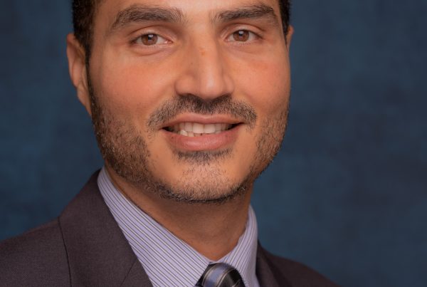 Loay Elbasyouni wearing a suit and tie.