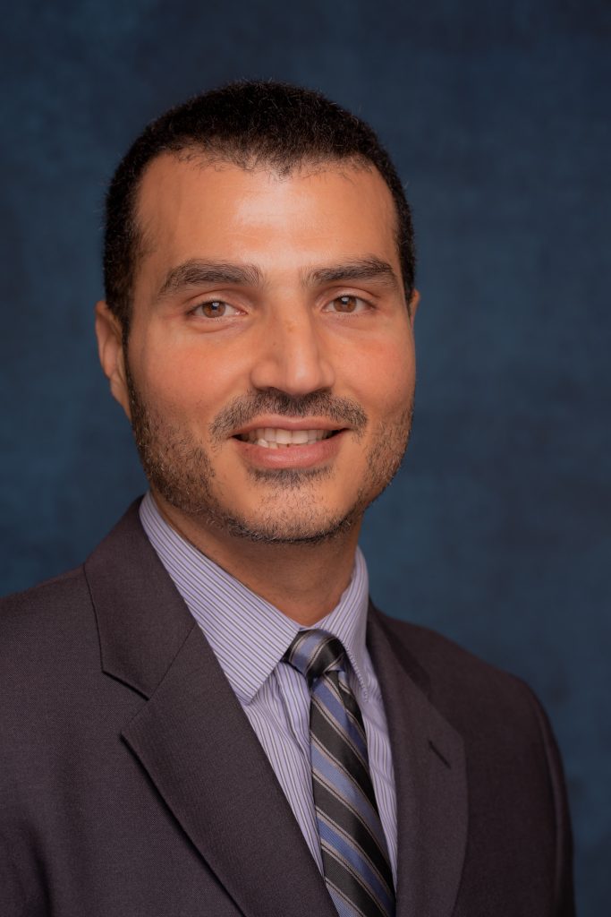 Professional headshot of Loay Elbasyouni wearing a suit and tie.