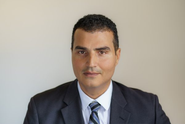 Loay Elbasyouni wearing a suit and tie.